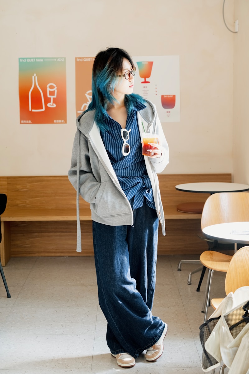 A woman with blue hair standing in a room