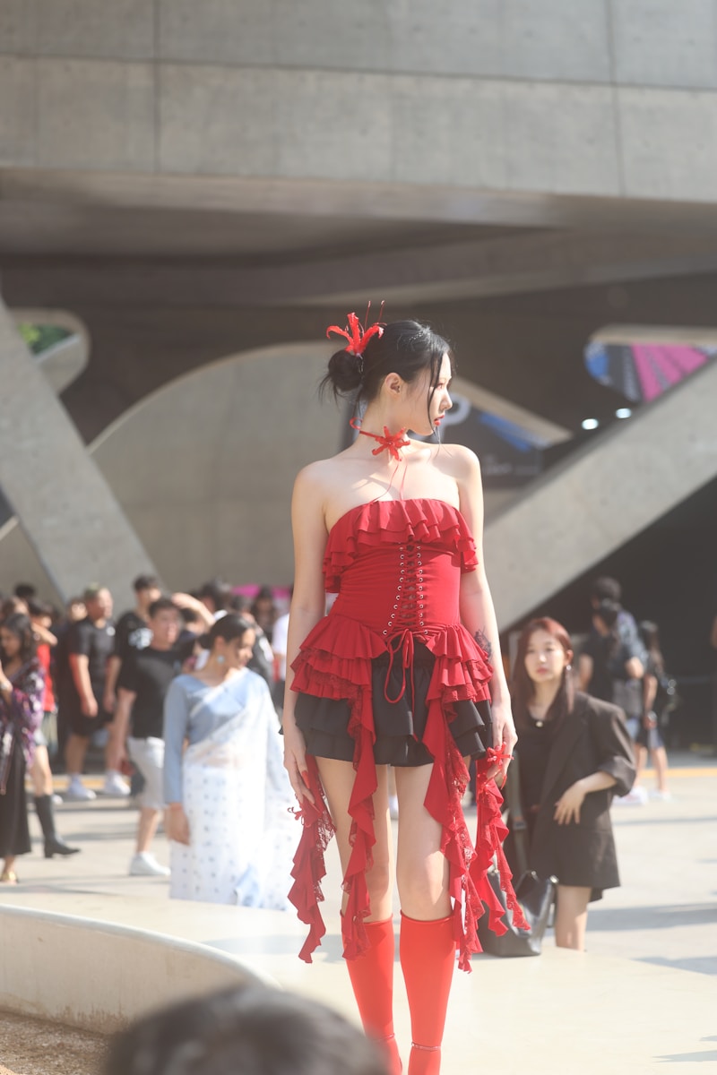 A woman in a red dress walking down a street